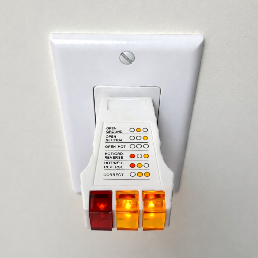 GroundLuxe outlet tester for grounding products showing a compact device with test indicator lights.