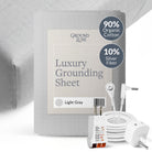 Dark gray GroundLuxe fitted grounding sheet made of organic cotton, king size 80x76 inches, lying flat on a bed.