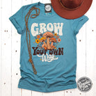 Heather blue Lagoon short sleeve graphic tee from Grow Your Own Way by The Graphic Tee, featuring a casual, stylish design.