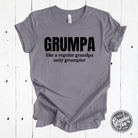 Heather gray graphic tee featuring a humorous "Grumpa, Like a Regular Grandpa Only Grumpier" design by The Graphic Tee.