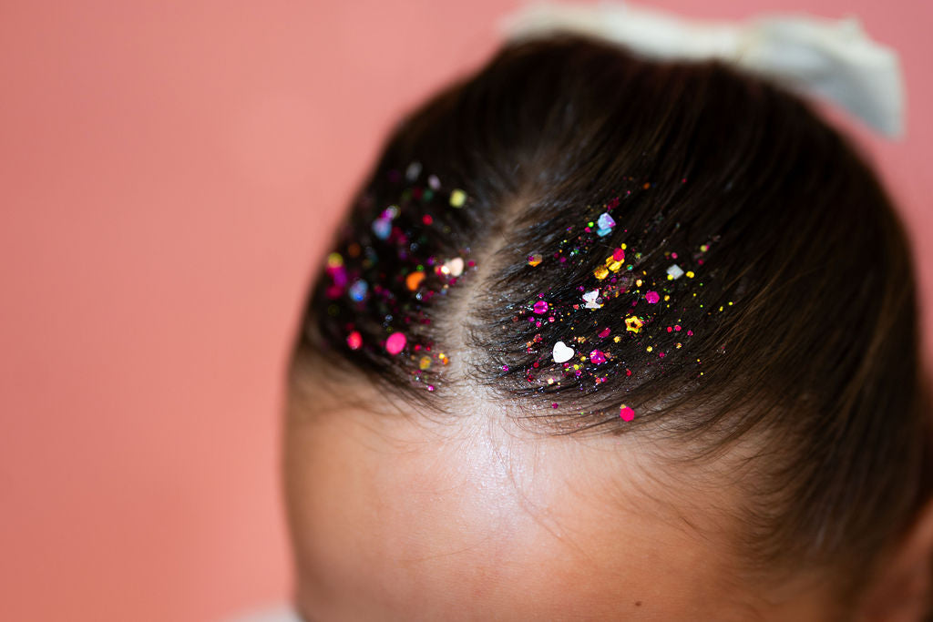 Multicolor hair glitter headband by Gussy Up Bow Co. with vibrant glitter accents and comfortable elastic band.
