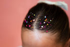 Multicolor hair glitter headband by Gussy Up Bow Co. with vibrant glitter accents and comfortable elastic band.