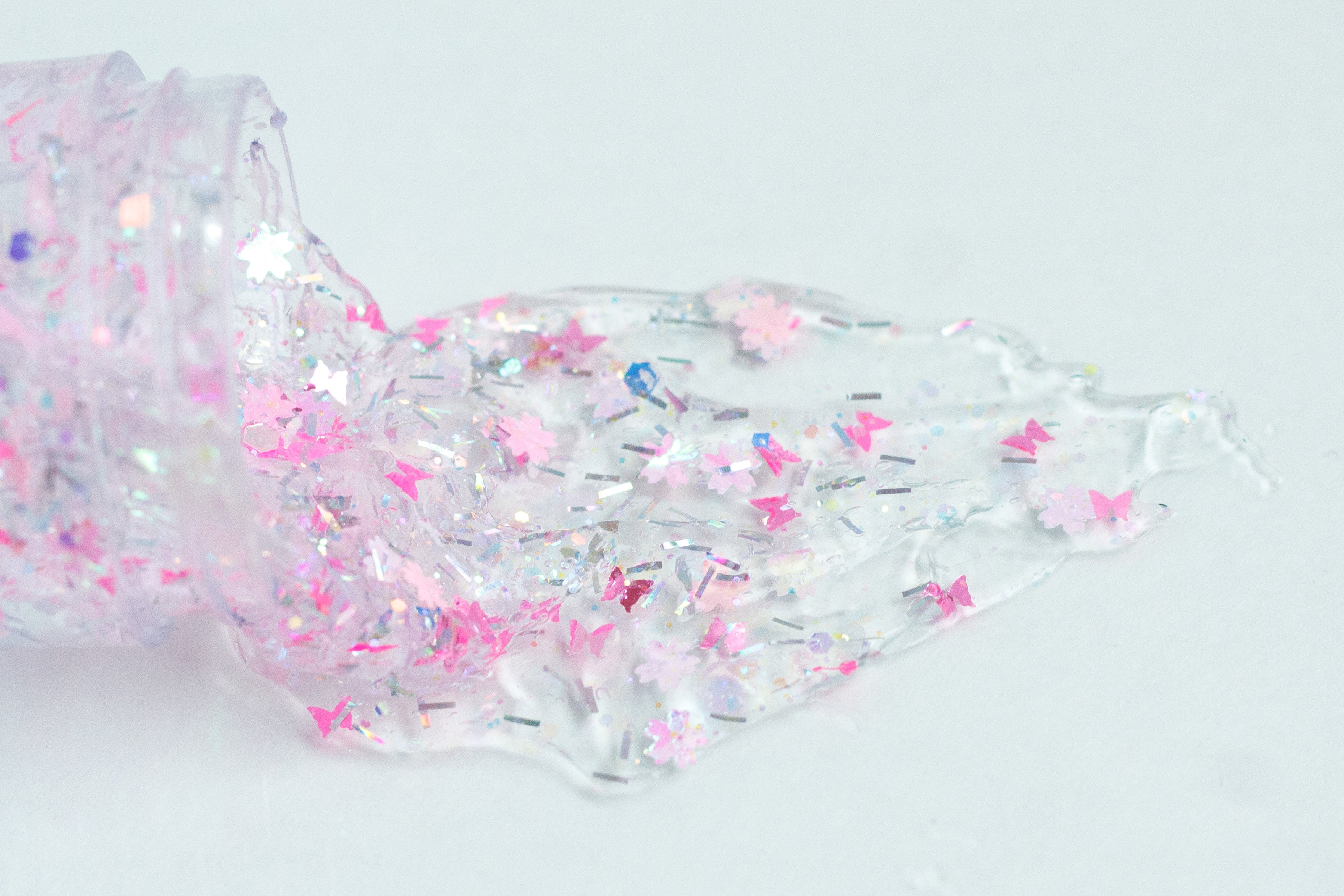 Gussy Up Bow Co. Secret Garden hair glitter headband with colorful glitter accents and floral design for festive hair styling.