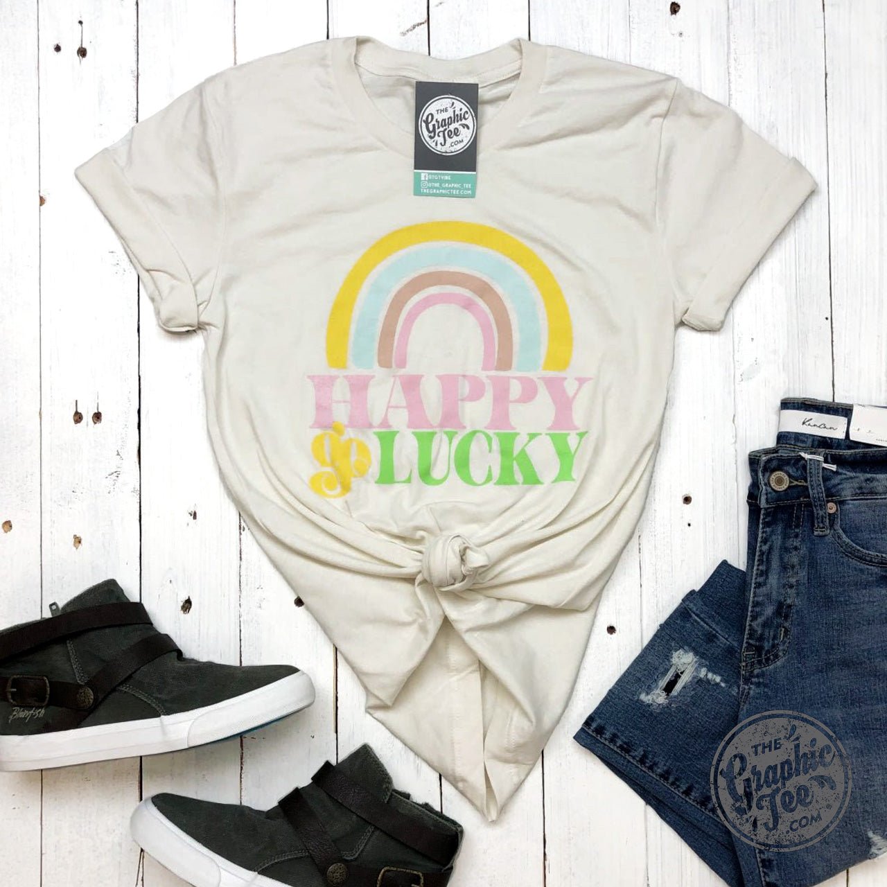 White crew neck graphic tee by The Graphic Tee featuring a vintage "Happy Go Lucky" design on the front.