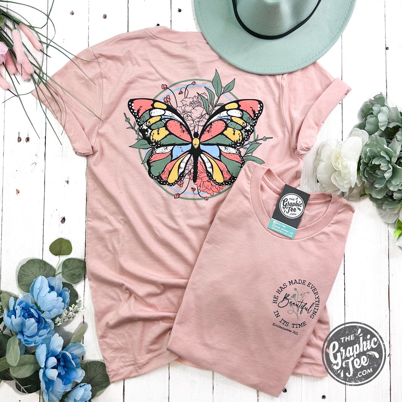 The Graphic Tee short sleeve graphic T-shirt with the phrase "He Has Made Everything Beautiful In Its Time" printed on a white fabric.