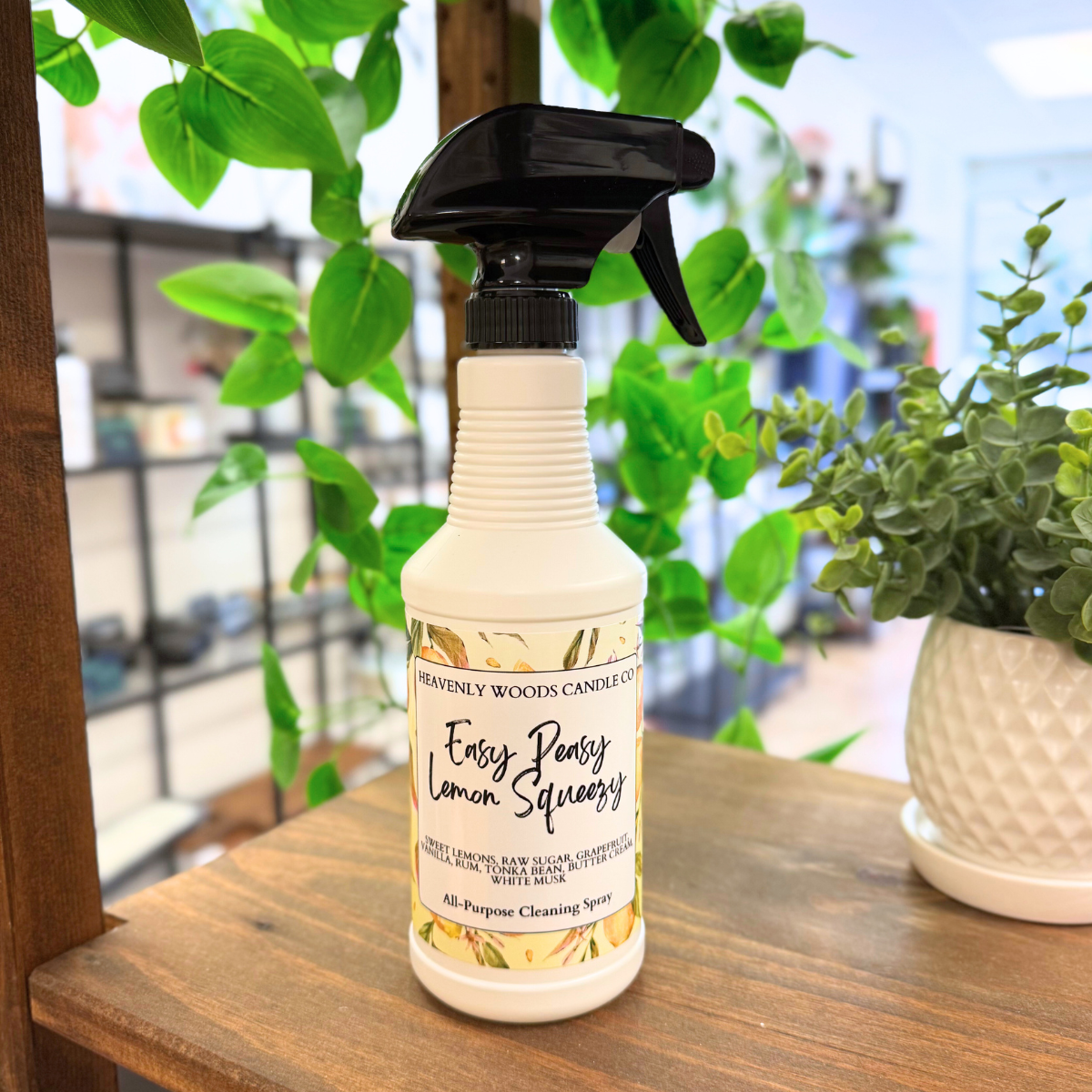 Heavenly Woods Candle Co Easy Peasy Lemon all-purpose cleaning spray bottle with lemon scent and spray nozzle.