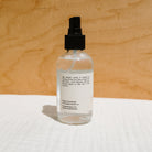 Face hydrosol by Honeybee Hippie with a clear spray bottle labeled Rose Hydrosol, used for skin and facial hydration.
