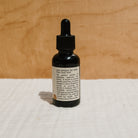 Honeybee Hippie hair and beard oil bottle showcasing natural hair and beard care for healthy, shiny hair and facial hair.