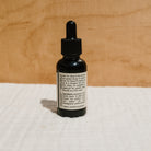 Bottle of Honeybee Hippie hair and beard oil, natural hair oil for nourishing and softening hair and facial hair.