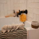 Postpartum herbal sitz bath by Honeybee Hippie, with dried herbs in a glass bowl for soothing postpartum care.