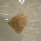 Herbal sitz bath by Honeybee Hippie for postpartum recovery, showing a herbal-filled sitz bath bowl with dried herbs inside.