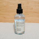 Bottle of Honeybee Hippie Butterfly Hydrosol with floral label, showcasing a natural floral hydrosol product in a clear glass bottle.