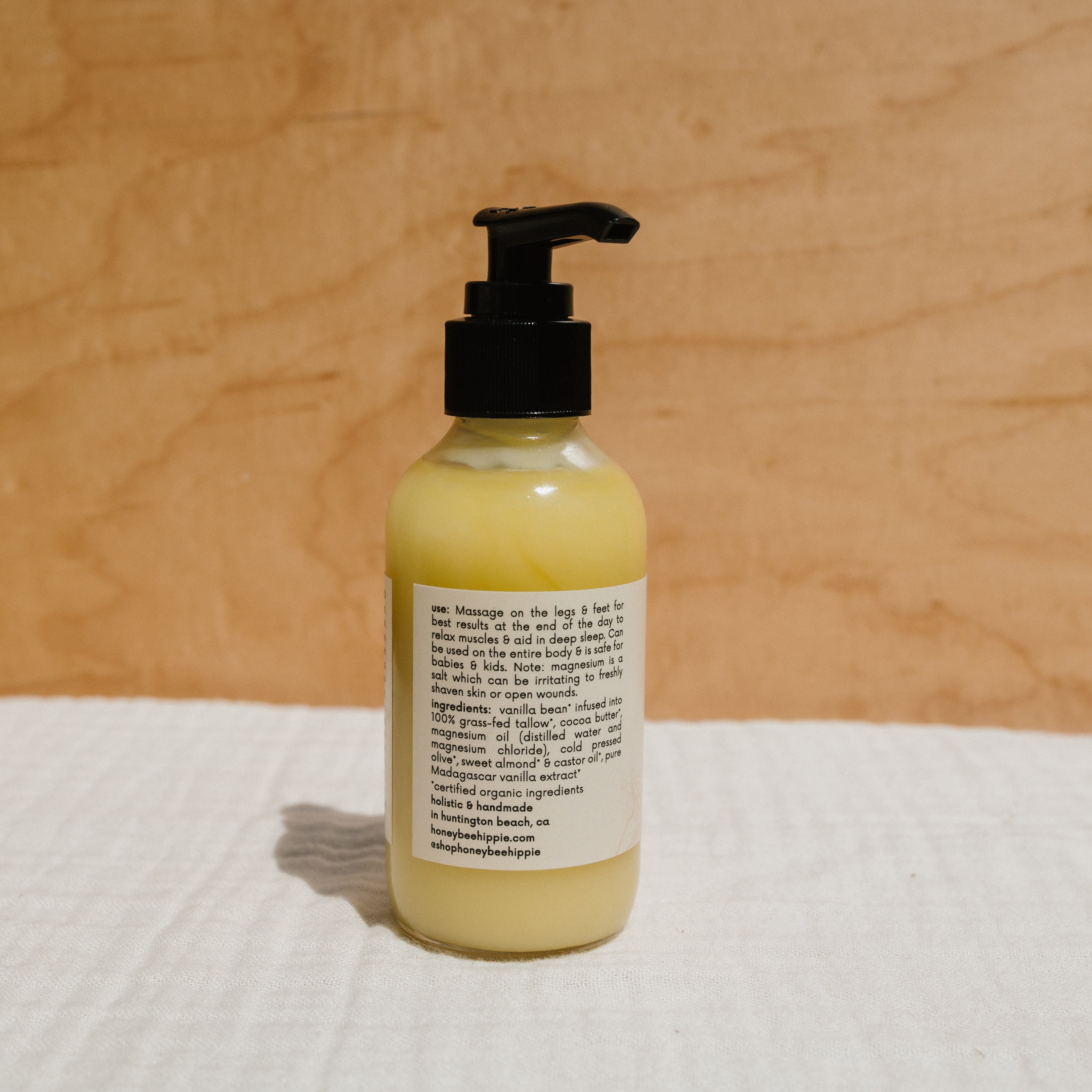 Creamy Honeybee Hippie Magnesium Butter jar with natural ingredients, showing the product label and smooth butter inside.