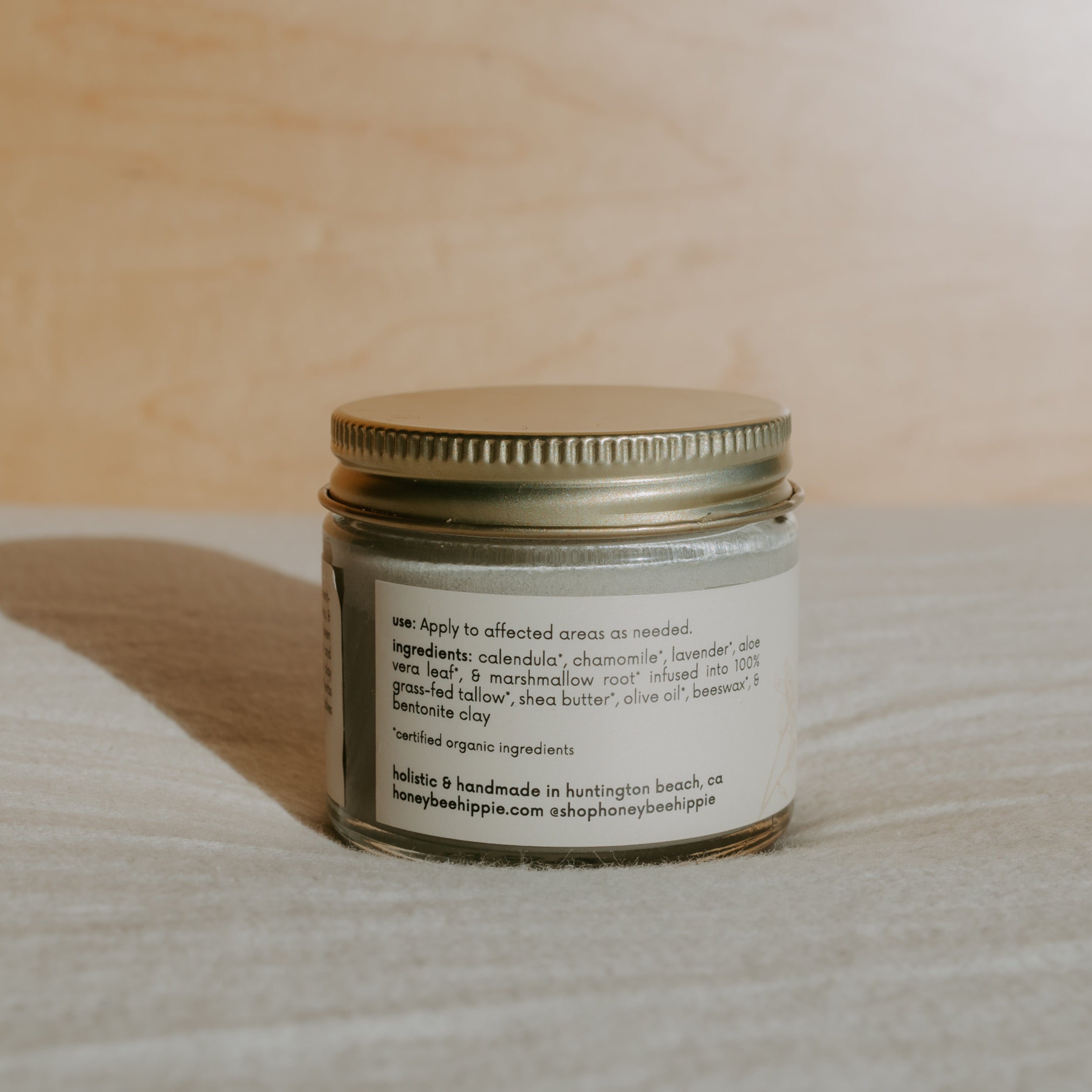 Honeybee Hippie Miracle Mud container with label, showcasing natural skincare product in a clear jar on a white background.