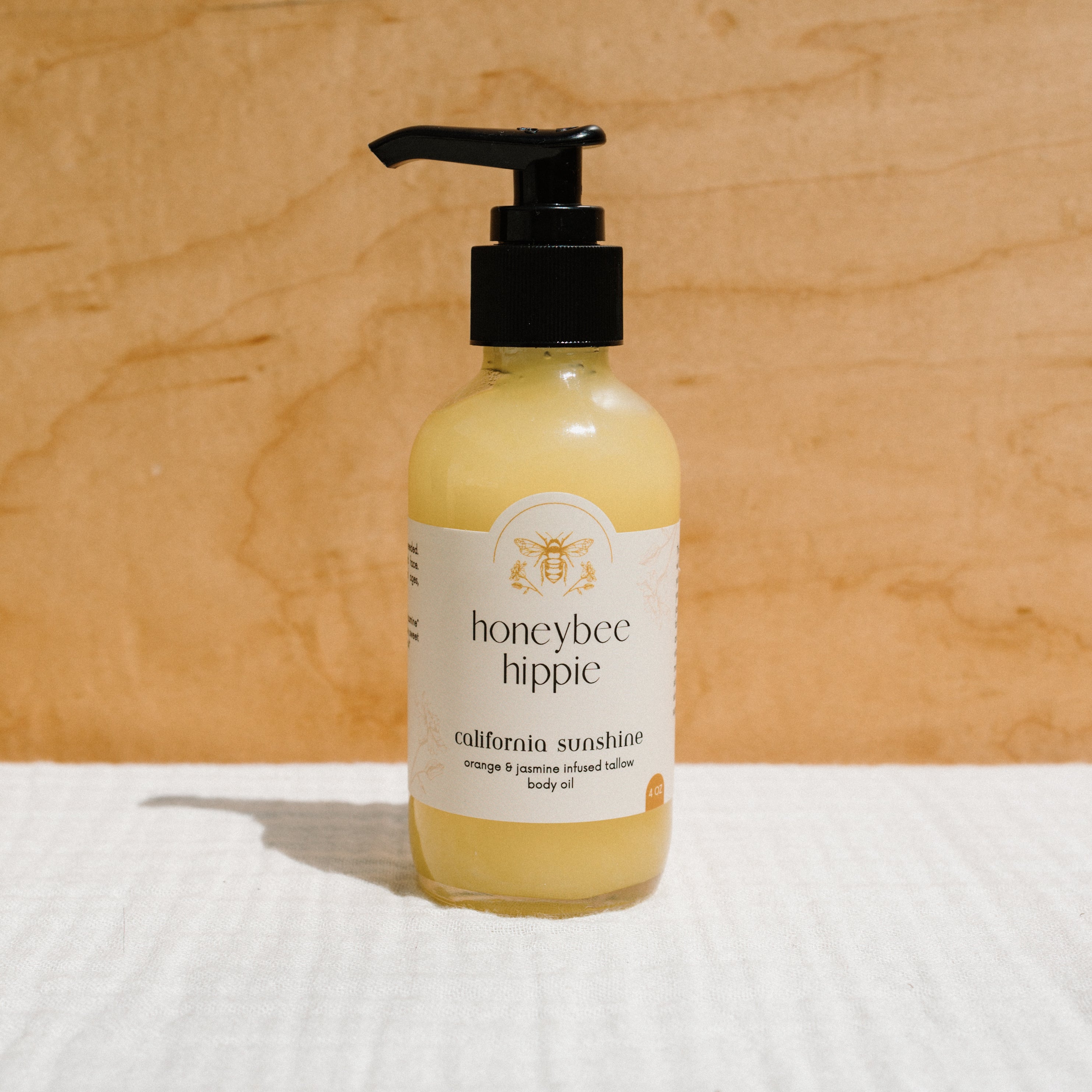 Honeybee Hippie California Sunshine Tallow Body Oil in a bottle, showcasing the natural tallow oil for skin nourishment.