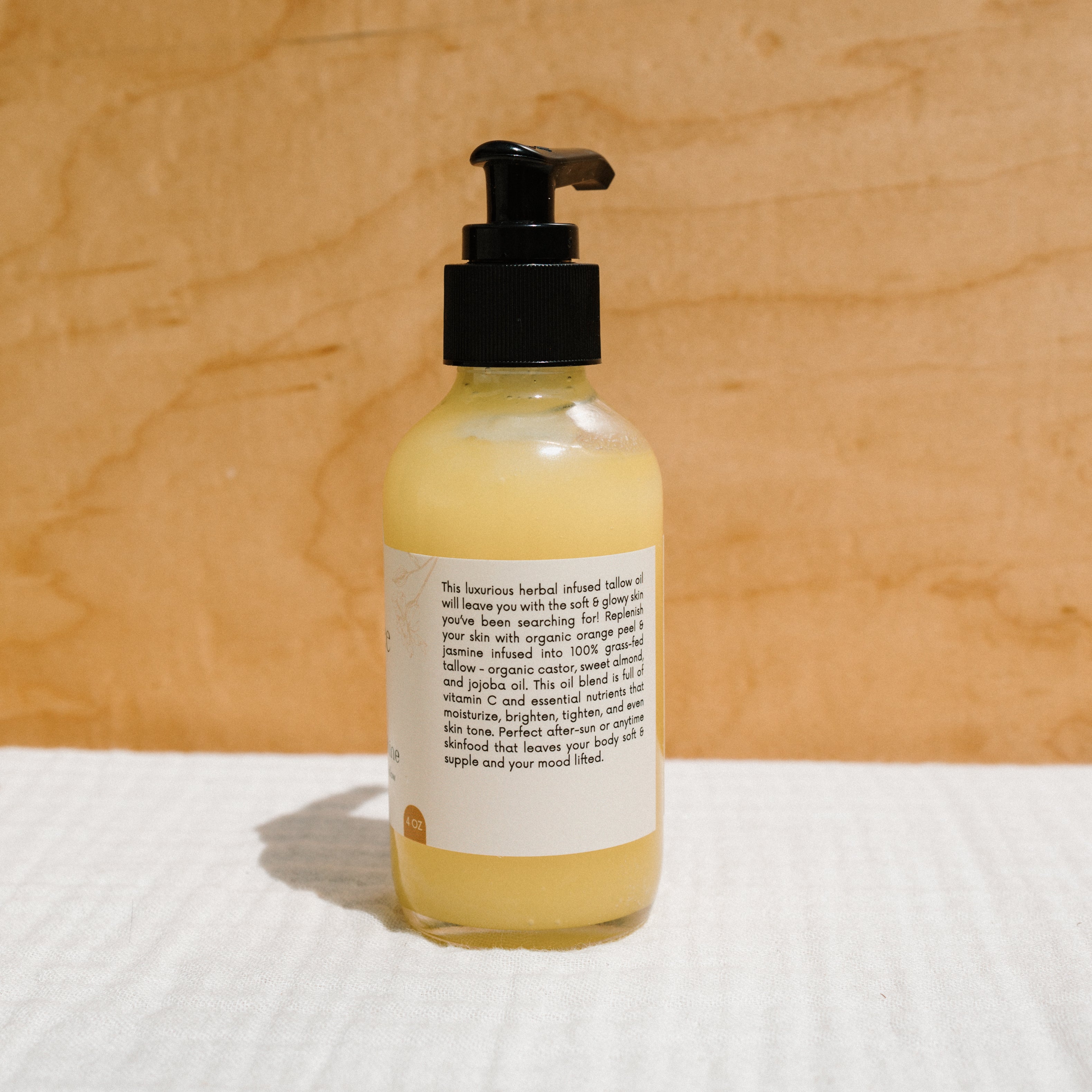 Honeybee Hippie California Sunshine Tallow Body Oil bottle with golden label and natural packaging.