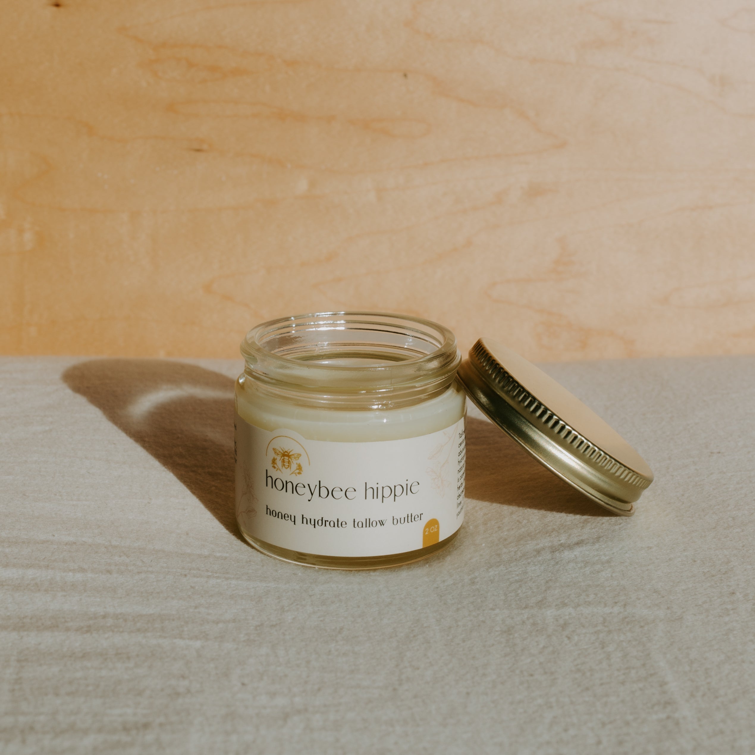 Honeybee Hippie Honey Hydrate Tallow Butter in a jar, showcasing creamy, natural tallow butter for skin hydration and nourishment.