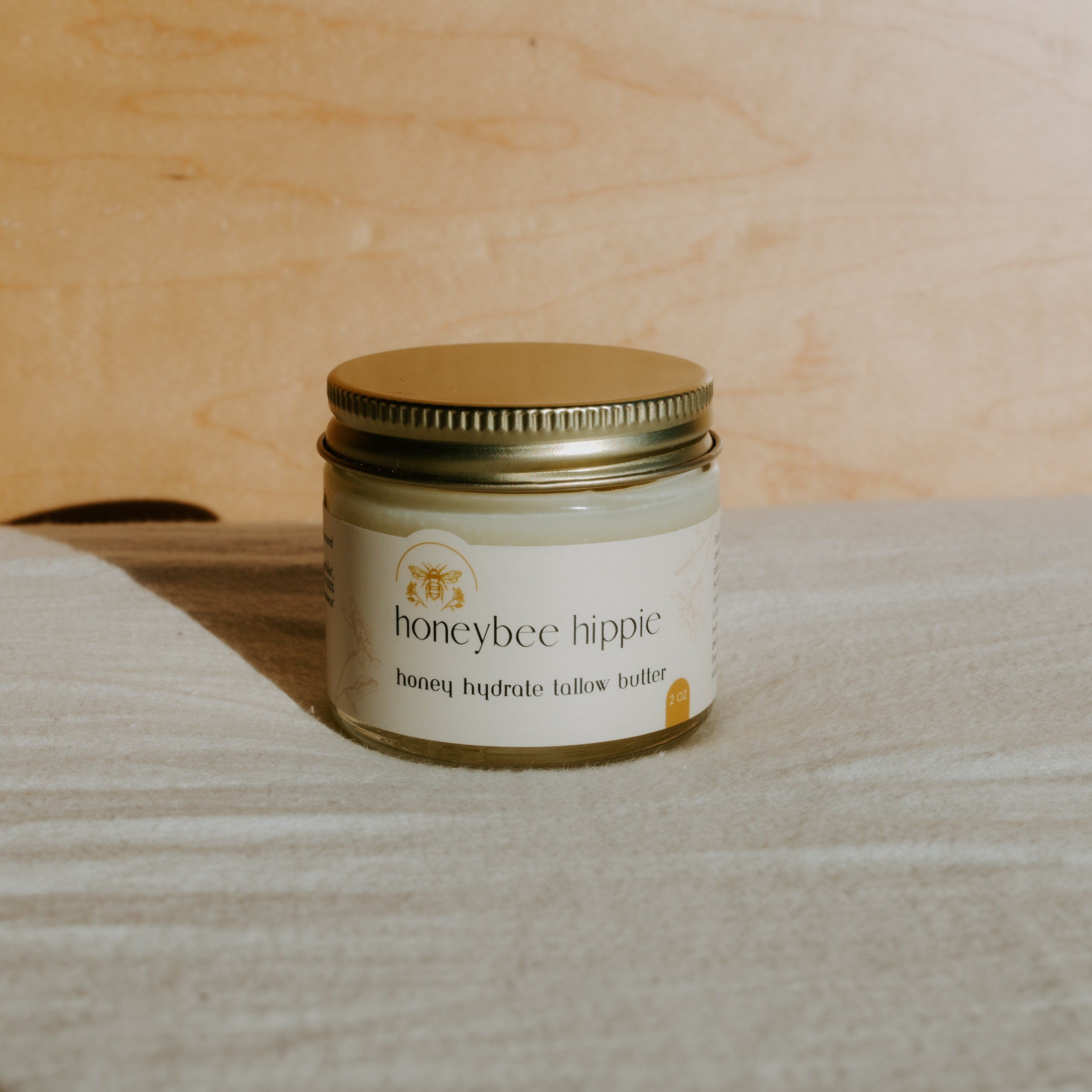 Creamy Honeybee Hippie Honey Hydrate Tallow Butter in a jar, showcasing its rich, smooth texture and natural ingredients.