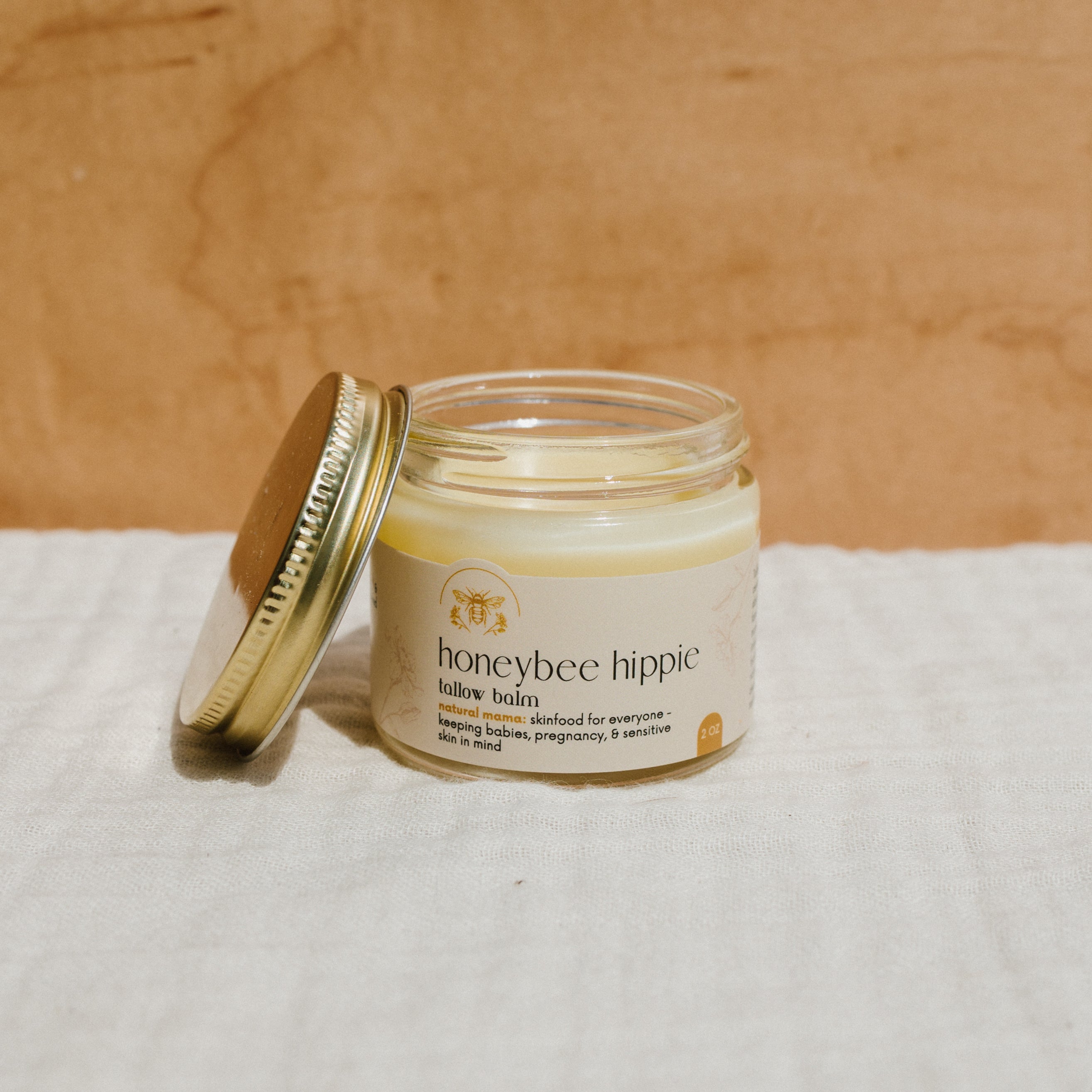 Natural Mama Tallow Butter in Honeybee Hippie Tallow Whip jar, showcasing creamy, rich tallow skincare product.