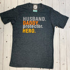 Father and husband superhero graphic tee from The Graphic Tee featuring a protective hero design on a casual SS T-shirt.