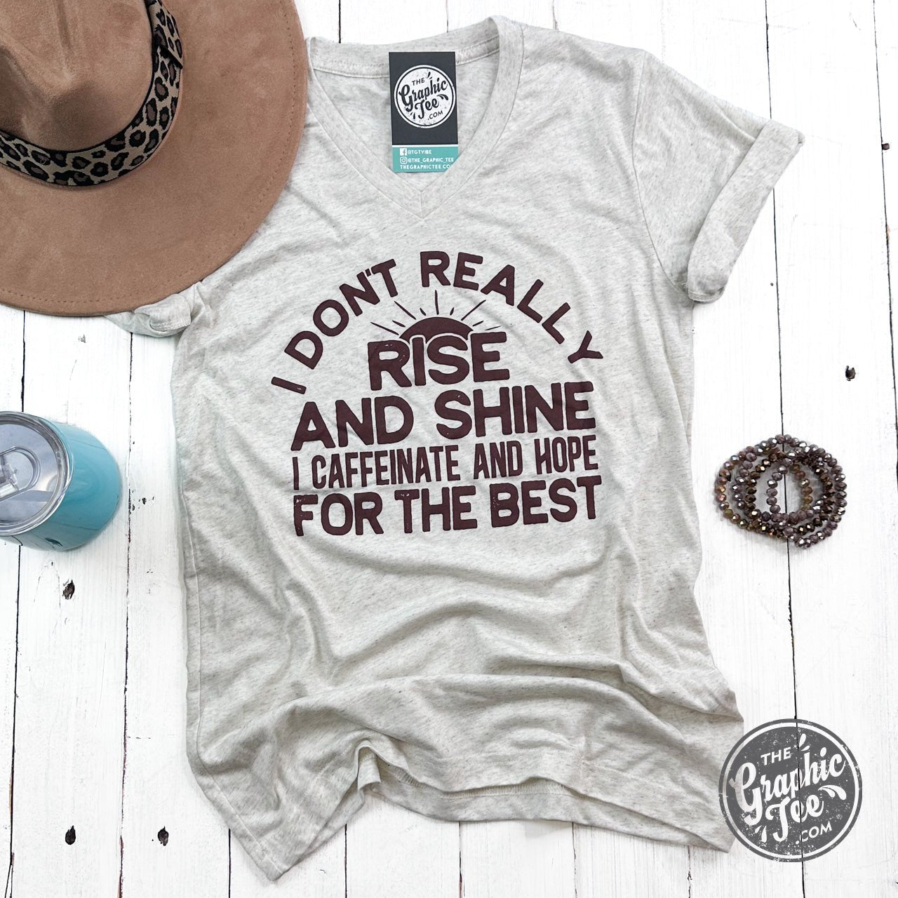 Gray short sleeve V-neck graphic tee from The Graphic Tee with "I Don't Rise and Shine" slogan on the front.