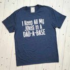 Adult graphic tee by The Graphic Tee featuring the humorous "I Keep All My Jokes In A Dad-A-Base" design on a short-sleeve shirt.