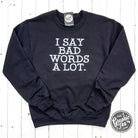 Black adult crewneck sweatshirt by The Graphic Tee featuring bold "I Say Bad Words A Lot" graphic design.