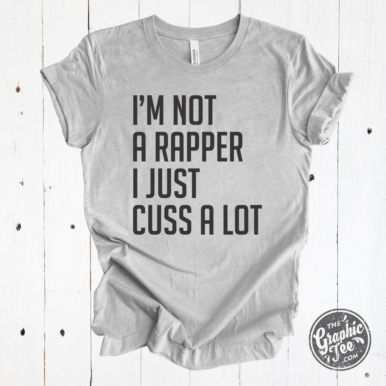 Grey unisex SS graphic T-shirt with humorous "I'm Not A Rapper I Just Cuss A Lot" print from The Graphic Tee brand.