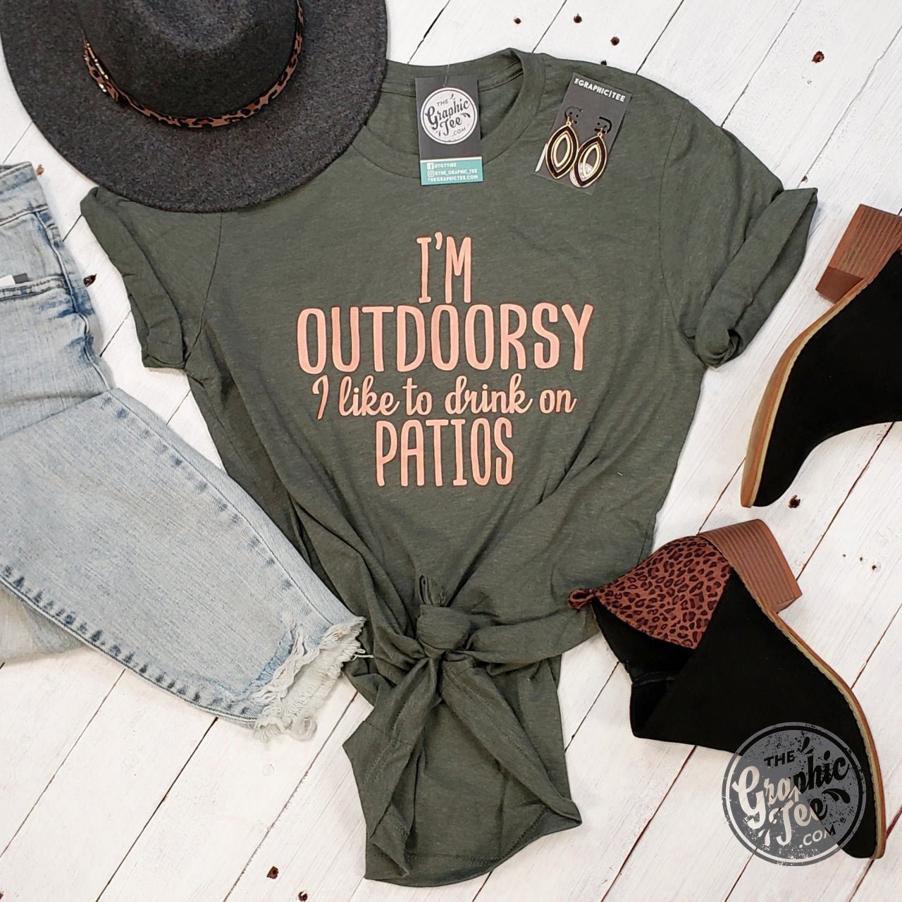 Unisex graphic t-shirt from The Graphic Tee, featuring a playful design with "I'm Outdoorsy" and patio drinking theme.