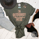 Unisex graphic t-shirt from The Graphic Tee, featuring a playful design with "I'm Outdoorsy" and patio drinking theme.