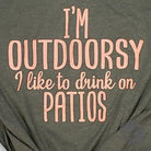 Unisex SS graphic tee from The Graphic Tee featuring "I'm Outdoorsy, I like to drink on patios" design on white fabric.