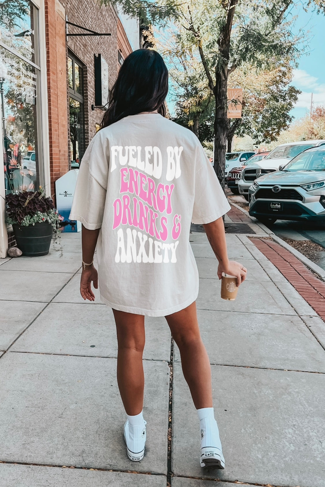 Graphic tee from Shop Karma Tees featuring a design inspired by energy drinks and anxiety themes on soft fabric.