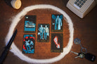 Insight Editions supernatural candle and tarot card deck bundle with candles, tarot cards, and mystical packaging on a wooden surface.