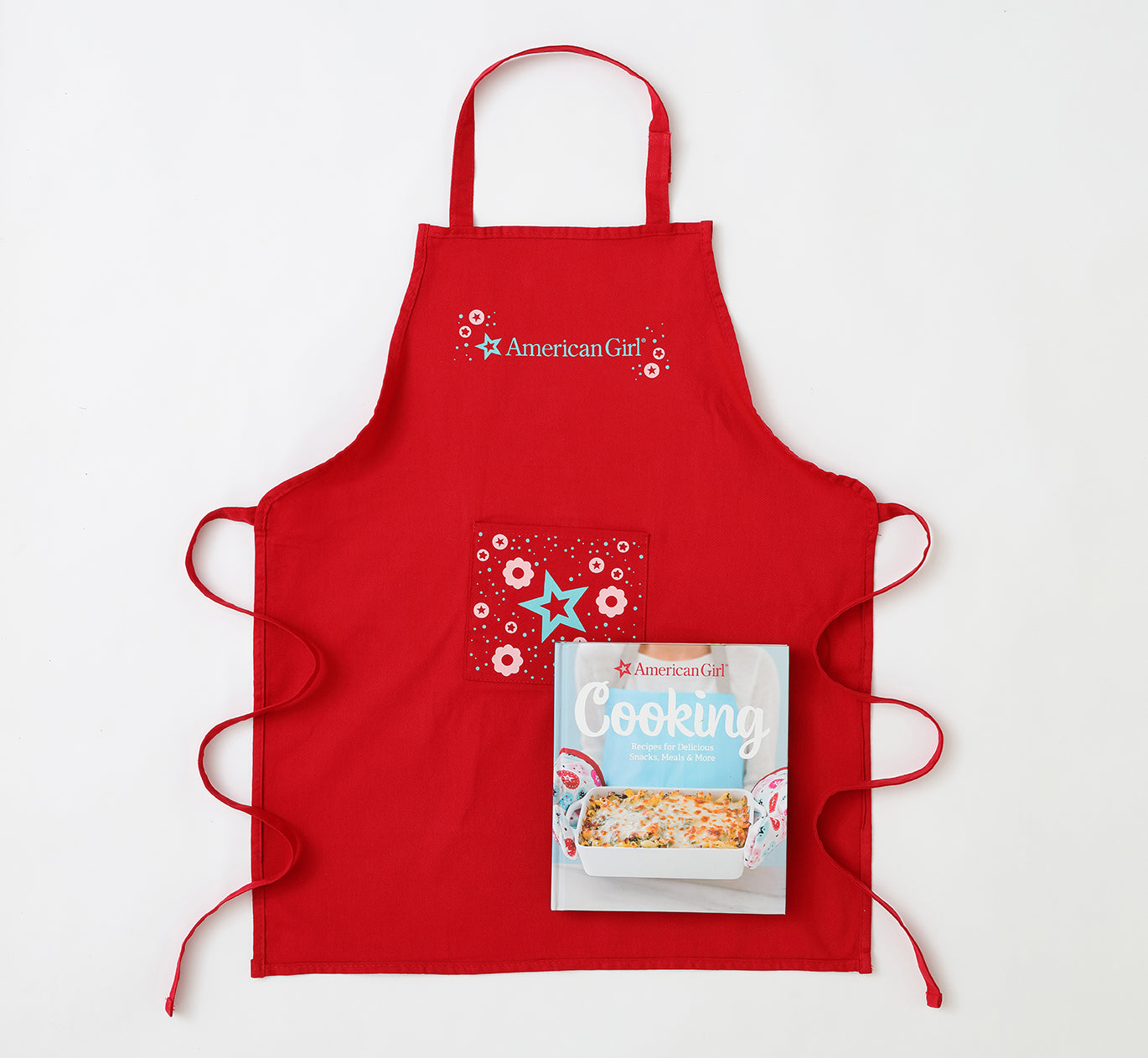 Hardcover American Girl Cooking Gift Set by Insight Editions with colorful illustrations and recipe pages inside.