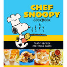 Hardcover Chef Snoopy Cookbook by Insight Editions featuring Snoopy sitting at a kitchen counter with cooking utensils.