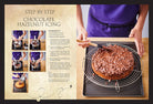 Hardcover Disney Enchanted Baking cookbook by Insight Editions showing a colorful dessert spread with whimsical baking decorations.
