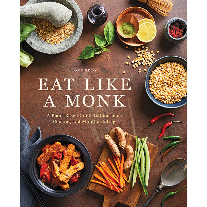 Hardcover copy of "Eat Like a Monk" cookbook by Insight Editions with a clean, minimalistic cover design.