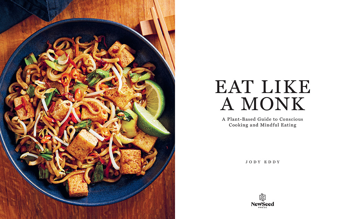 Hardcover copy of "Eat Like a Monk" cookbook by Insight Editions with a plain cover design.