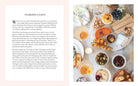 Hardcover book titled "Entertaining with Charm" by Insight Editions, featuring decorative interior pages and charming design elements.