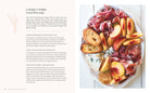 Hardcover book titled "Entertaining with Charm" by Insight Editions featuring elegant design and decorative interior pages.