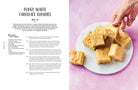 Hardcover copy of Fitwaffle's Baked in One cookbook by Insight Editions featuring a colorful cover with baked goods.