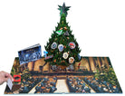 Hardcover Harry Potter: A Hogwarts Christmas Pop-Up book by Insight Editions with detailed magical Christmas scenes and pop-up illustrations.