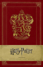 Gryffindor hardcover ruled journal from Harry Potter series by Insight Editions, featuring Gryffindor crest and wizard-themed design.