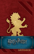 Gryffindor hardcover ruled journal from Harry Potter series by Insight Editions, featuring house crest and gold accents.