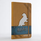 Harry Potter Hufflepuff hardcover ruled journal by Insight Editions with Hufflepuff crest and gold accents on the cover.
