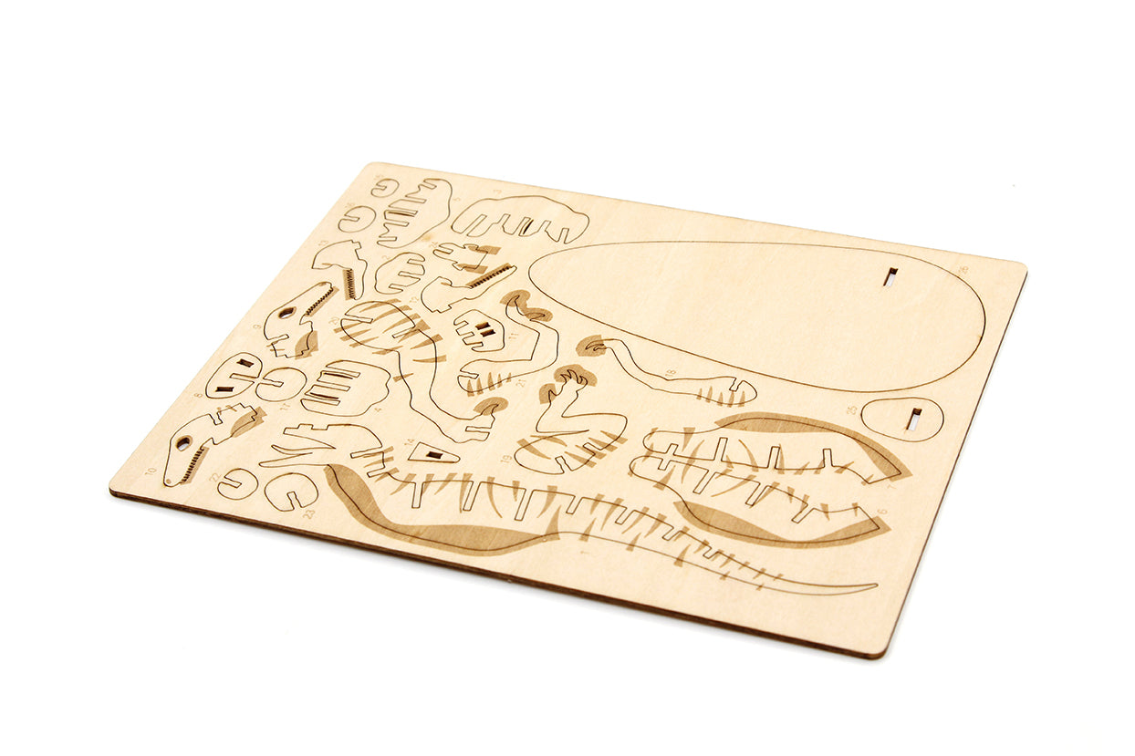 Hardcover IncrediBuilds Jurassic World Raptor book and 3D wood model by Insight Editions, featuring a detailed dinosaur design.
