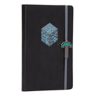 Hardcover Minecraft Diamond Ore Journal with charm by Insight Editions, featuring a diamond ore design and a decorative charm.