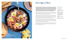Hardcover copy of "Out There: A Camper Cookbook" by Insight Editions, featuring outdoor cooking recipes and camping tips.
