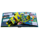 Hardcover Paws Claws and Snapping Jaws pop-up book by Insight Editions showing colorful animal illustrations and intricate paper pop-ups.