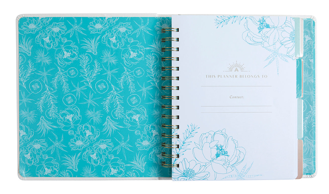 Hardcover Insight Editions Self-Care 12-Month Undated Planner with floral cover and weekly planning pages.